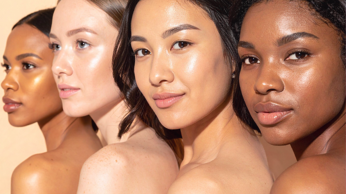 Four diverse women with radiant, glowing skin posing confidently, representing healthy and luminous skin over 40.